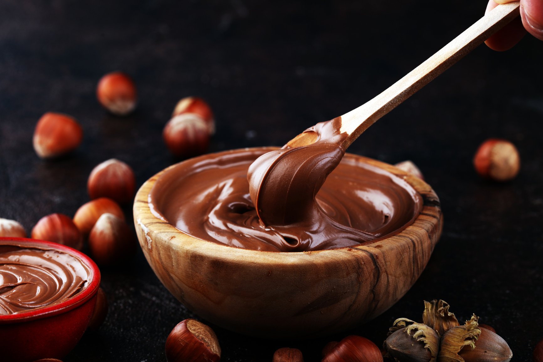 Homemade hazelnut spread in wooden bowl. Hazelnut Nougat cream with hazelnuts